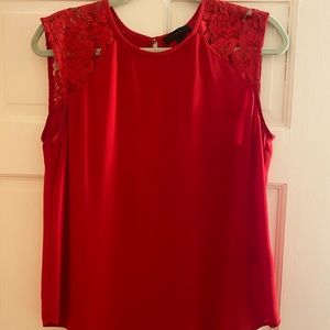 JCrew red top with lace sleeves. Double gold button closure on back.